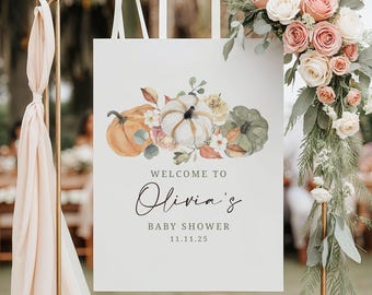 May include: A white sign with a floral pumpkin design, announcing "Welcome to Olivia's Baby Shower" with the date 11.11.25. The sign is decorated with watercolor pumpkins, flowers, and greenery, perfect for a fall-themed baby shower.