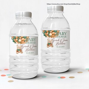 May include: Two clear plastic water bottles with white caps. Each bottle has a label that reads "BABY SHOWER" with the names "Sarah & James Baldwin" and the date "01.25.2023". The labels feature a teddy bear and balloons.