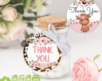 May include: A glass jar with a cork stopper and a white ribbon, filled with white sweets. A round tag with the words "Thank You" in pink, surrounded by pink roses and a cow print border. Another tag features a cartoon Highland cow.