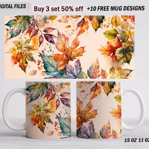 May include: White ceramic mugs with a watercolor design of autumn leaves in shades of orange, yellow, green, and purple. The mugs are 15 oz and 11 oz. The image also includes the text "Buy 3 set 50% off +10 FREE MUG DESIGNS".