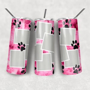 May include: Three cylindrical tumblers with a pink and white watercolour background, black paw prints, and multiple blank white-bordered photo frames. Each tumbler features a thin metal straw inserted into the lid at the top of the vessel.