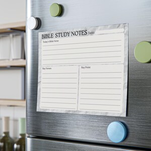 May include: A rectangular Bible study notes notepad with a marble-like background is attached to a refrigerator with round magnets. The notepad has sections for "Today's Bible Verse," "Key Verses," and "Key Point."