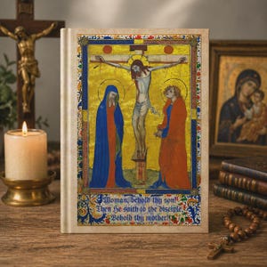 May include: A hardcover book with a religious illustration depicting the crucifixion of Jesus Christ. The artwork features figures in blue, red, and gold hues, with text at the bottom. A candle, a crucifix, and a rosary are also visible.