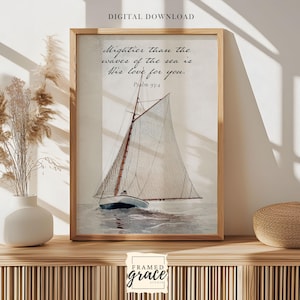 May include: A framed watercolor print featuring a sailboat on the water. The print includes the text "Mightier than the waves of the sea is His love for you. Psalm 93:4." The frame is a light brown color. The words "DIGITAL DOWNLOAD" are at the top.
