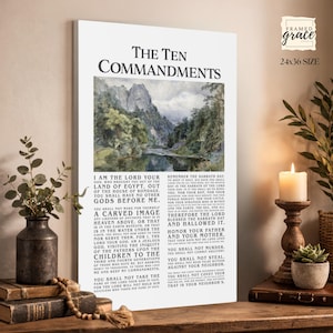 May include: A framed canvas print featuring the Ten Commandments with a landscape image. The artwork is 24x36 inches and includes the text of the commandments. A candle, plant, and decorative vase are in the foreground.