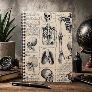 May include: A spiral-bound notebook with a vintage anatomical illustration design featuring skulls, skeletons, and handwritten text. The notebook is open, displaying the detailed drawings in black and white.
