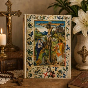 May include: A hardcover book with a religious painting on the cover, depicting the crucifixion of Jesus. The cover has an ornate border with floral and scroll designs. A gold crucifix, a lit candle, and a vase of white lilies are in the background.