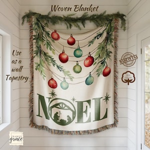 May include: Woven Christmas tapestry featuring red, green, and blue baubles suspended from a string, with the word "NOEL" and a nativity scene. Made from 100% cotton, suitable for use as a wall tapestry.