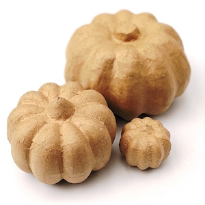 May include: Three brown paper mache pumpkins of varying sizes. The largest pumpkin is smooth, while the two smaller pumpkins have a textured, ribbed surface.