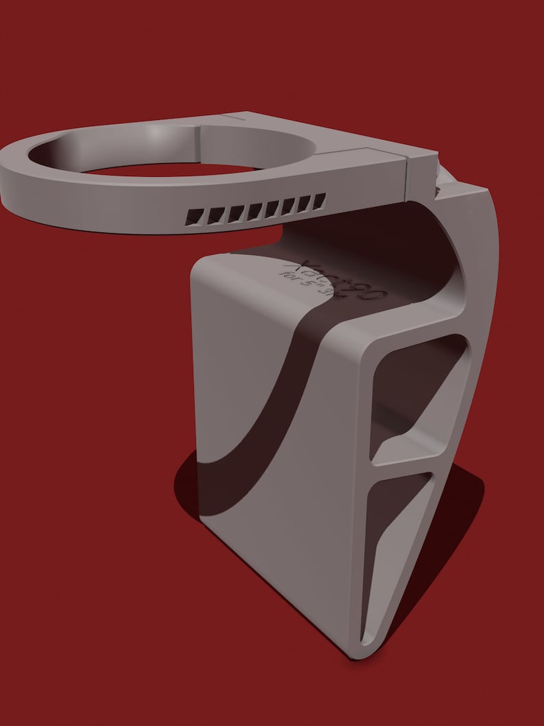 May include: A gray 3D printed phone holder with a circular top and a textured design. The holder has a curved base and a series of slots on the side.