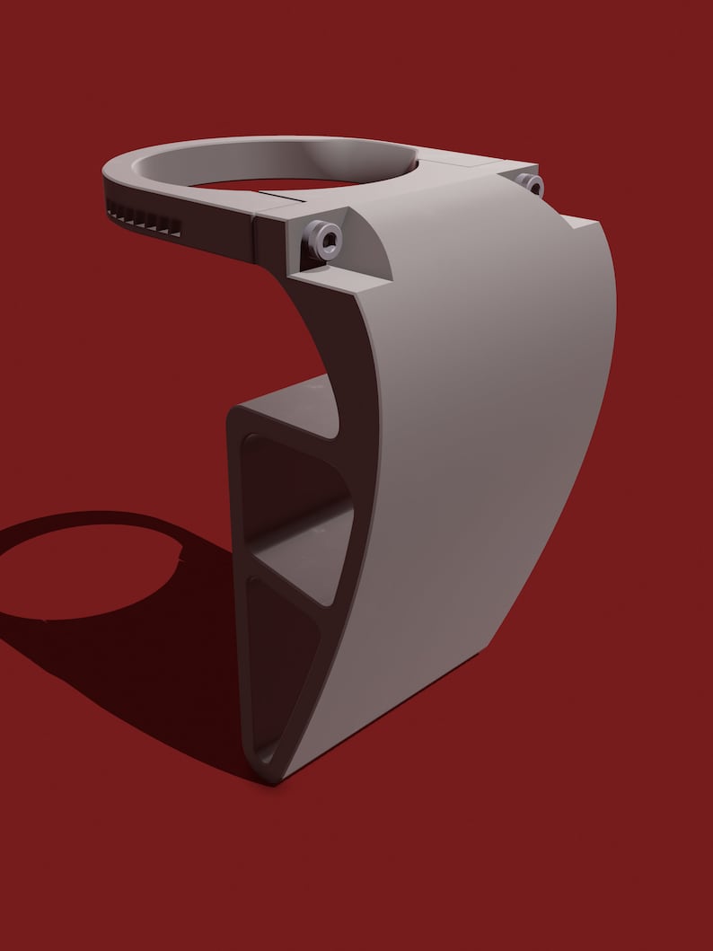 May include: A gray 3D printed phone holder with a circular top and a curved base. The holder has a textured surface and a small hole on the side.