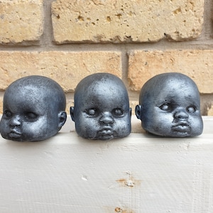Stone  creepy dolls head