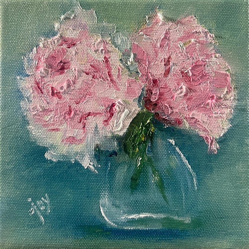 May include: Oil painting of pink peonies in a clear glass vase, set against a teal background. The flowers have textured brushstrokes, with green leaves and stems. The artist's signature, "joy", is in the lower left corner. The artwork is square.
