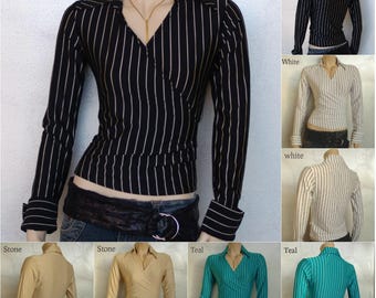 May include: A black and white striped wrap top with long sleeves. The top has a collared neckline and is shown in multiple colors, including white, stone, and teal. The brand name "Trikuta Designs" is visible in the image.