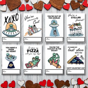 May include: Eight printable Valentine's Day cards featuring alien-themed illustrations and puns. The cards are white with black text and colorful illustrations. The text on the cards includes "You're astronomically cool", "You're out of this world!" and "You have a pizza my heart".