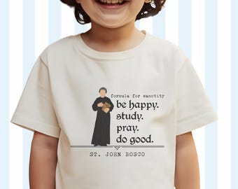 May include: A white t-shirt with a black illustration of a man holding a book. The text on the shirt reads "formula for sanctity be happy. study. pray. do good. ST. JOHN BOSCO".