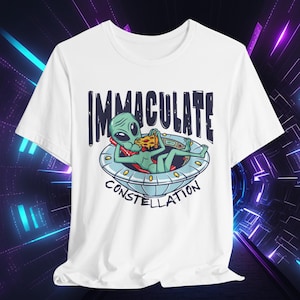 May include: White t-shirt with a green alien eating pizza in a flying saucer. The text "Immaculate Constellation" is printed on the shirt.
