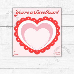 May include: A pink and red Valentine's Day card with a large heart design. The card says "You're a Sweetheart" and has space to write "to:" and "from:".