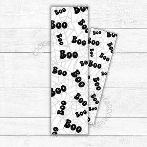 May include: Two white Halloween-themed bookmarks with a repeating pattern of the word "Boo" in black, interspersed with gray spiderwebs. The bookmarks are rectangular and have a slightly angled design.