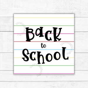 May include: A square sign featuring a white background with horizontal lines in yellow, green, pink, red, and blue. The text "Back to School" is printed in a bold, black, stylized font across the center of the sign, with a watermark visible.