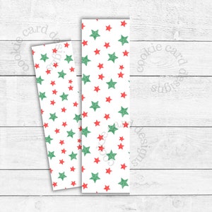 May include: Two white bookmarks with a pattern of red and green stars. The stars are scattered across the surface of the bookmarks. The text "cookie card designs" is visible in the background.
