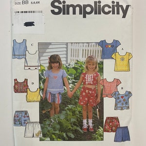 May include: Simplicity sewing pattern number 7626 for girls' clothing sizes BB, 5, 6, and 6X. The pattern includes instructions for making a variety of tops and shorts with different designs, including hearts, flowers, and gingham patterns.