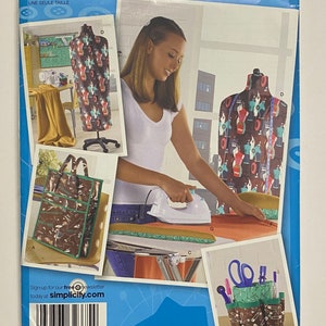 May include: A sewing pattern for a dress, tote bag, and sewing organizer. The pattern is from Simplicity and is inspired by Project Runway. The pattern number is 2720 and is for one size.