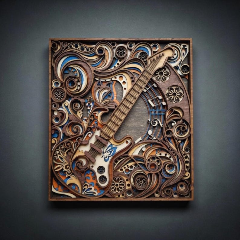 May include: A wooden, layered art piece featuring a guitar design. The guitar is light-colored with blue accents, set against a backdrop of swirling, layered patterns in shades of brown, orange, and blue. The artwork is framed in a dark wooden border.