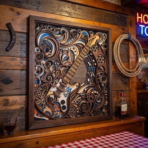 May include: A wooden wall art piece featuring a layered design of a guitar with floral and scrollwork details. The artwork is framed in a dark wood, with blue, white, and orange accents. The background is a rustic wooden wall.