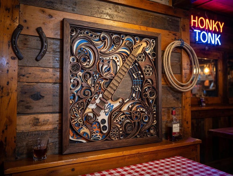 May include: A wooden wall art piece featuring a layered design of a guitar with floral and scrollwork details. The artwork is framed in a dark wood, with blue, white, and orange accents. The background is a rustic wooden wall.