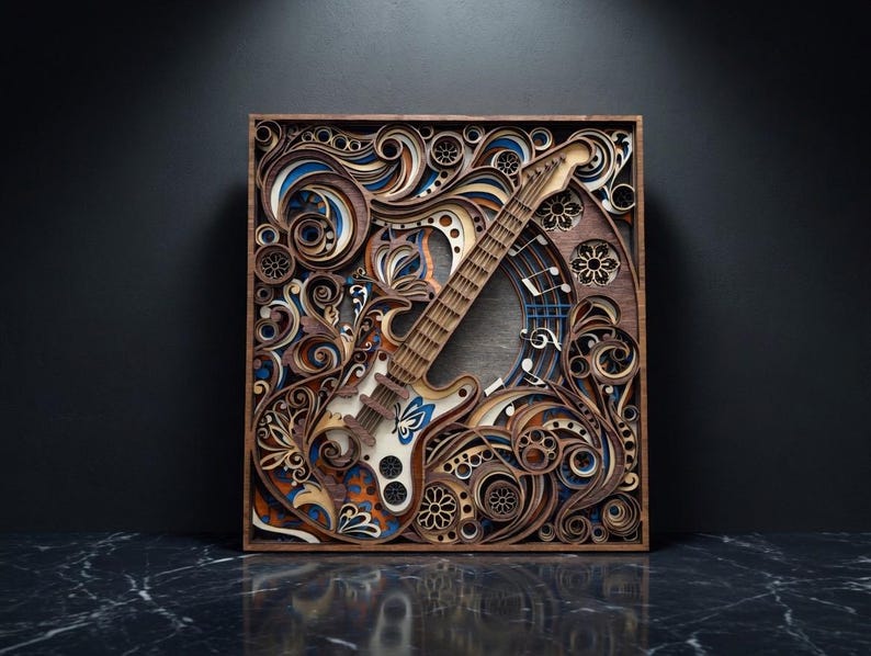 May include: A wooden, multi-layered wall art piece featuring a guitar design. The artwork is framed in a square, with intricate cut-out patterns and swirls in shades of brown, blue, and orange. The guitar is centered, with a detailed fretboard and body.