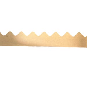 May include: A long, thin, cardboard picture hanger with a series of evenly spaced, upward-pointing triangular peaks along one edge. The cardboard is a light tan colour, and the background is white.
