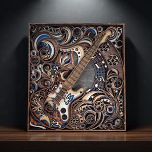 May include: A wooden, layered art piece featuring a guitar design. The guitar is white and brown, with blue and orange accents. The artwork is set within a dark brown frame, showcasing intricate floral and swirl patterns.