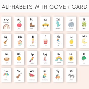 May include: A set of alphabet flashcards with colorful illustrations for each letter. The flashcards feature a variety of objects, including an apple, boot, car, dinosaur, elephant, frog, guitar, house, ice cream, jam, kite, lemon, moon, nest, orange, parrot, queen, rainbow, sunflower, tree, umbrella, violin, watermelon, xylophone, yarn, and zebra.