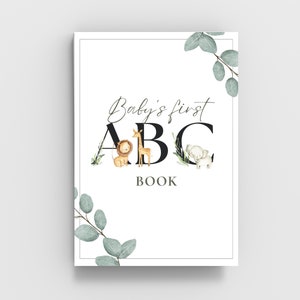 May include: A white book cover with the text "Baby's first ABC BOOK" in black script font. The letters A, B, and C are large and black with illustrations of a lion, giraffe, and elephant, respectively.