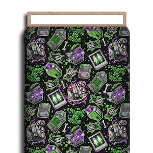 May include: A black and green patterned fabric featuring a repeating design of cartoon ghosts, tombstones, and the text "Strange and Unusual". The design also includes beetles and other spooky elements.