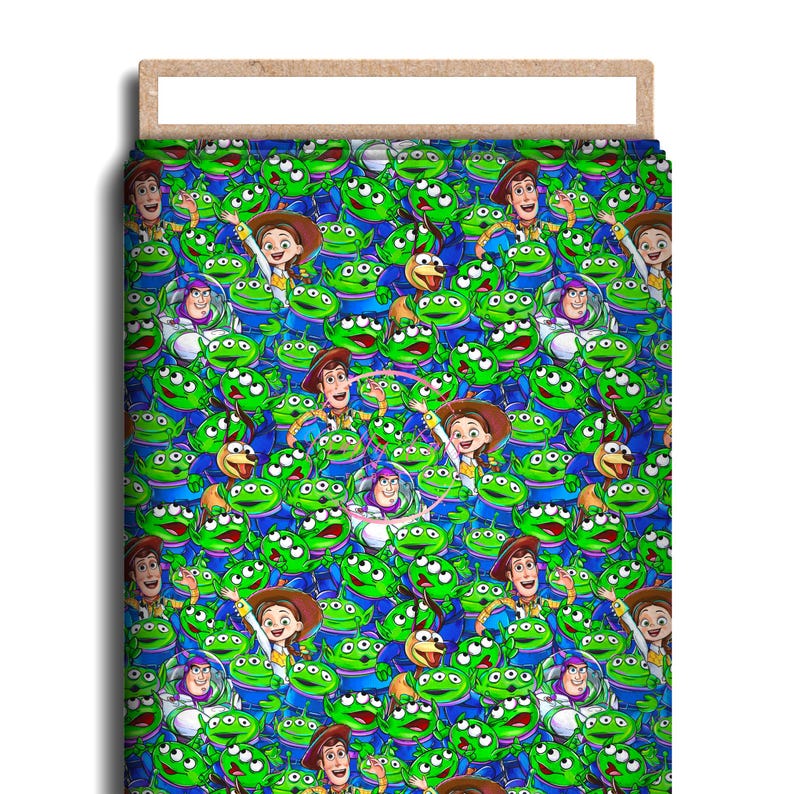 May include: A bed sheet featuring a repeating pattern of characters from the animated film Toy Story. The design includes green aliens, Woody, Jessie, and Buzz Lightyear on a blue background. The sheet is rectangular and has a wooden frame.