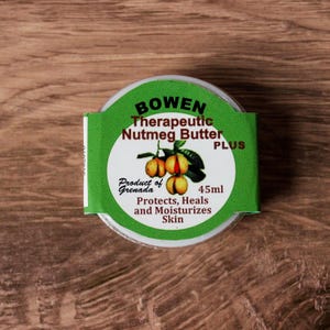 May include: A jar of Bowen Therapeutic Nutmeg Butter PLUS, 45ml. The label is green and white, with text and an illustration of nutmeg fruit. The product is from Grenada and protects, heals, and moisturizes skin.