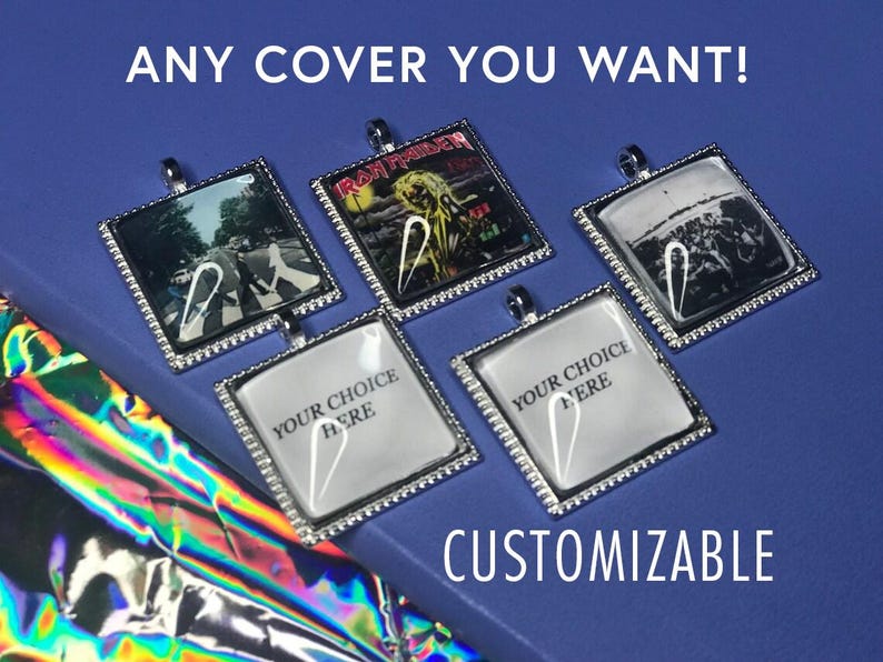 May include: Five silver-toned pendants with glass inserts. The pendants feature different images, including a band logo, a street scene, and a blank space with the text "Your Choice Here".