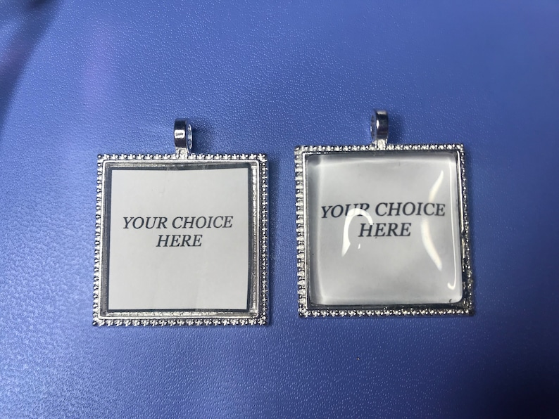 May include: Two silver-toned square picture frames with a beaded border. The frames are blank and have the text "Your Choice Here" printed on them.