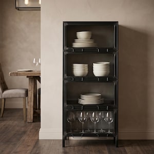 May include: A black metal cabinet with glass doors, displaying white crockery and glassware. The cabinet has four sections, each with stacks of plates, bowls, and wine glasses. The design is modern and minimalist, suitable for kitchen or dining room storage.
