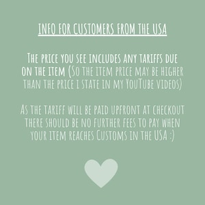 May include: A light green background with white text providing information for customers in the USA. The text explains the price includes tariffs. A white heart is at the bottom of the image.