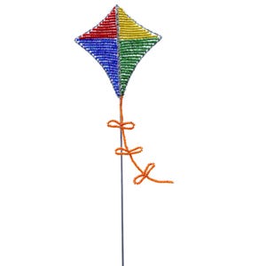 May include: A colorful beaded kite with a red, yellow, green, and blue design. The kite is attached to a thin wire with an orange string tied in a bow.
