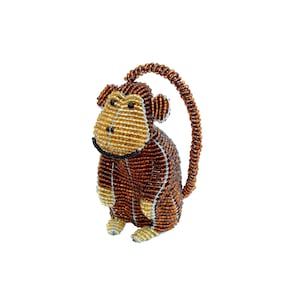 May include: A beaded monkey ornament with a brown and gold color scheme. The monkey is sitting with its tail curled around its body.