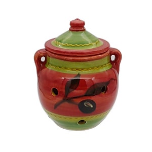 May include: Red and green ceramic jar with a lid and an olive branch design. The jar has holes in the sides and is ideal for storing olives or other small items.
