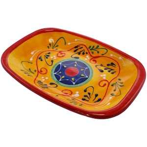 May include: A yellow ceramic rectangular serving dish with a red rim. The dish has a colourful floral design with a blue and red centre circle.