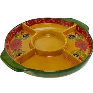 May include: A yellow ceramic serving dish with four sections and a central dip. The dish has a green rim and handles, and is decorated with red and green floral designs.