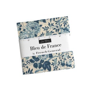May include: A stack of fabric squares with a floral pattern in shades of blue and cream. The fabric is wrapped with a white band that reads "Bleu de France" by French General. The fabric squares are approximately 8 inches wide.