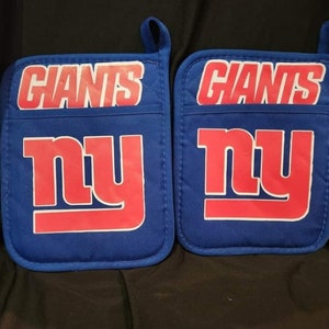 May include: A pair of blue oven mitts with the New York Giants logo. The logo is red and white and says "Giants" and "NY".