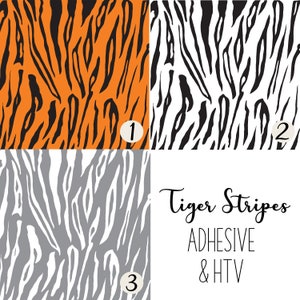May include: Three different tiger stripe patterns in orange, black, and white, and gray. The patterns are labeled with numbers 1, 2, and 3. The text "Tiger Stripes ADHESIVE & HTV" is below the patterns.